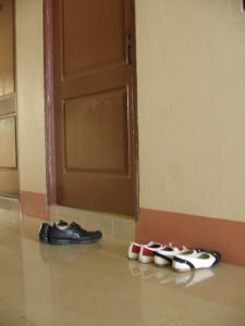 Sepatu di depan kost putri 